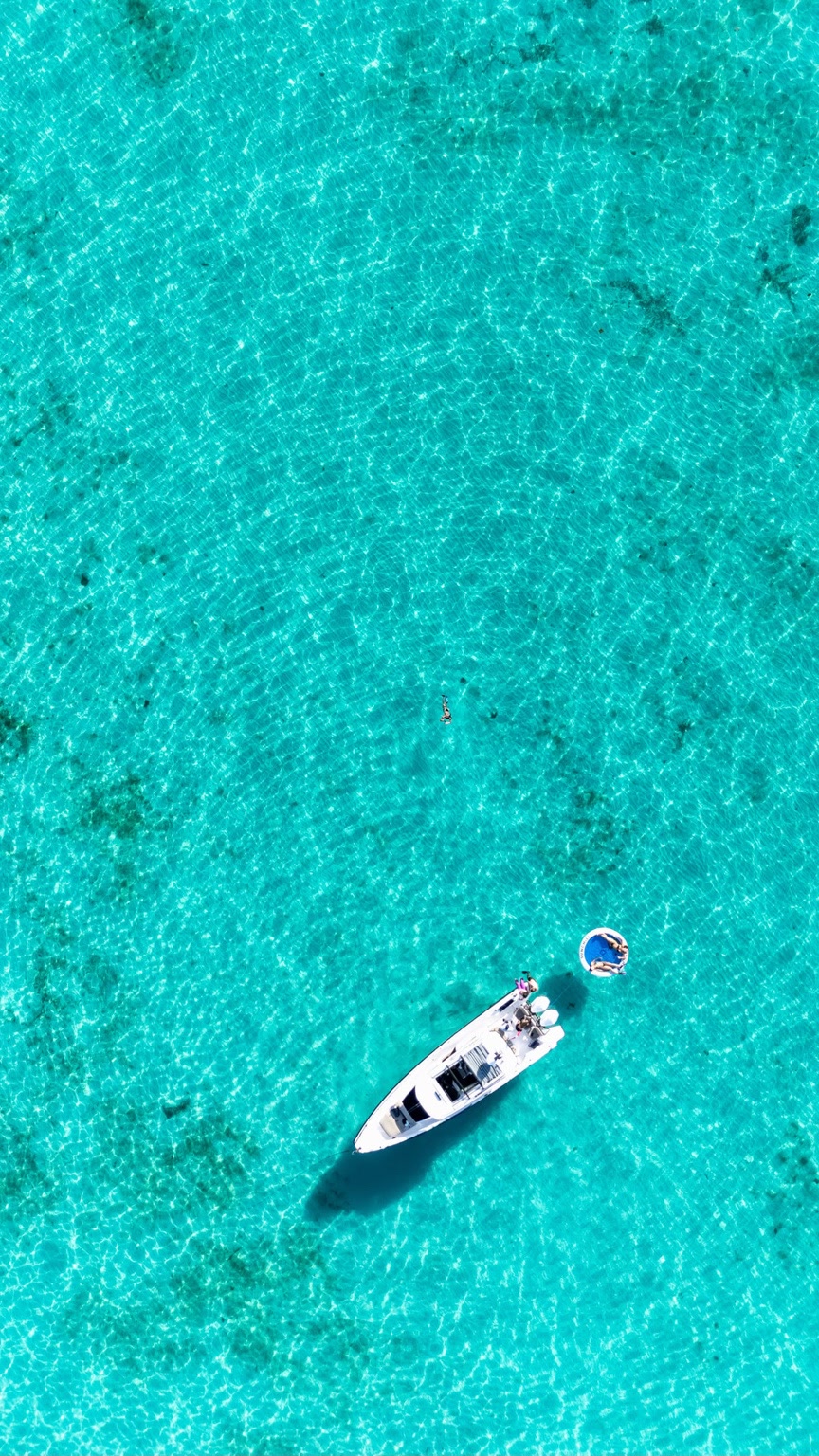 An Axopar anchored in clear turquoise Florida Keys water, photographed from above